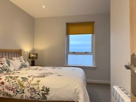 A bedroom with a bed and lamp at Amber Rose in Berwick-upon-Tweed