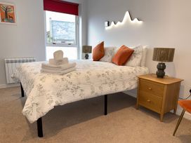 A bedroom with a double bed and bedside table at Amber Rose in Berwick-upon-Tweed