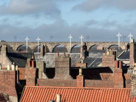 A view of rooftops with a viaduct in the background at Amber Rose in Berwick-upon-Tweed
