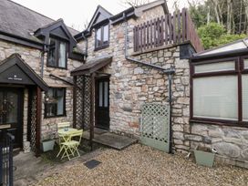 An outdoor area with a yellow table and chairs at Ivy Cottage in Abergele