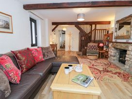 A living room with a sofa and coffee table at Ivy Cottage in Abergele