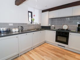A kitchen with a toaster, kettle, and oven at Ivy Cottage in Abergele