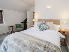 A bedroom with a bed and bedside tables at Ivy Cottage in Abergele