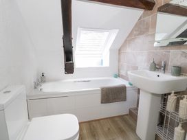 A bathroom with bathtub and sink at Ivy Cottage in Abergele