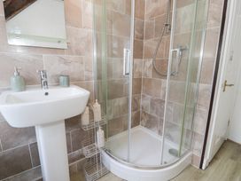 A bathroom with a shower and sink at Ivy Cottage in Abergele