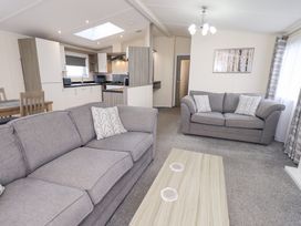 A living room with sofas and a coffee table at Lily's Lodge in Morecambe