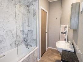A bathroom with shower and bathtub at Lily's Lodge in Morecambe