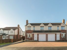 A house with a driveway and garages at Sandy Cove in Chathill