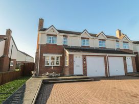 A house with a garage and driveway at Sandy Cove in Chathill