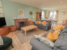 A living room with a sofa and coffee table at Sandy Cove in Chathill