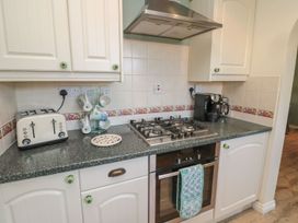 A kitchen with appliances and utensils at Sandy Cove in Chathill
