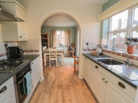 A kitchen with a sink and stove at Sandy Cove, Chathill