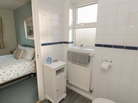 A bathroom with a window and sink at Sandy Cove in Chathill