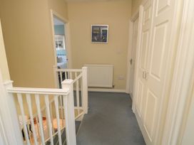 A hallway with doors and a radiator at Sandy Cove in Chathill