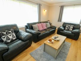 A living room with sofas and a coffee table at Min Y Cae