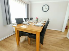 A dining room with a table set for dinner at Min Y Cae 