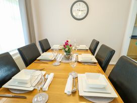 A dining room with a table set for meals at Min Y Cae
