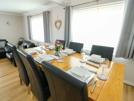 A dining room with a table and chairs at Min Y Cae