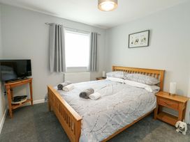 A bedroom with a bed and TV at Min Y Cae