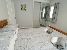 A bedroom with a bed and towels at Min Y Cae