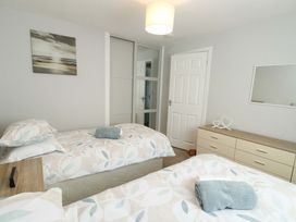 A bedroom with two beds and a dresser at Min Y Cae