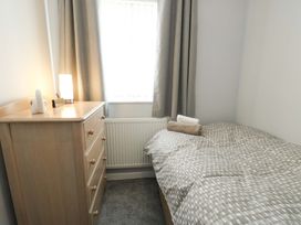 A bedroom with a bed and chest of drawers at Min Y Cae 