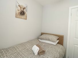A bedroom with a bed and towels at Min Y Cae in 