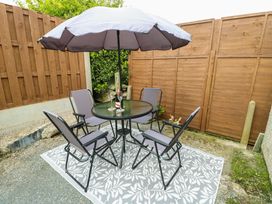 An outdoor seating area with a table and chairs at Min Y Cae 