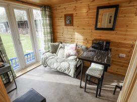 A snug with a sofa and table at Mardi Gras in Wisbech