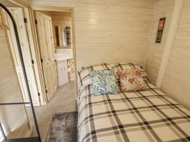 A bedroom with a bed and attached bathroom at Mardi Gras in Wisbech