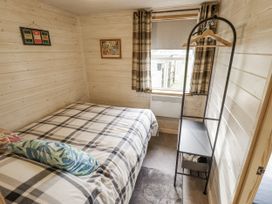 A bedroom with a bed and shelf at Mardi Gras in Wisbech