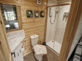 A bathroom with a shower and toilet at Mardi Gras in Wisbech