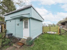 A shed with a door and a table at Mardi Gras in Wisbech