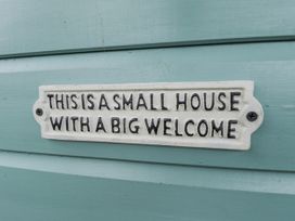 A sign reading This is a small house with a big welcome at Mardi Gras in Wisbech