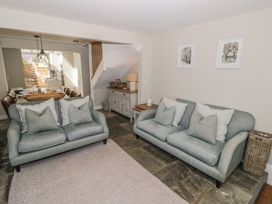 A living room with sofas and a dining area visible at Tea Tree Cottage in Chipping Campden