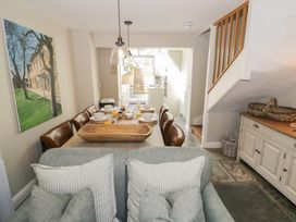 A dining room with a table set for meals at Tea Tree Cottage in Chipping Campden