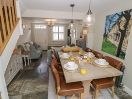 A dining room with a table set for meals at Tea Tree Cottage in Chipping Campden