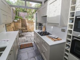 A kitchen with a stove and countertop at Tea Tree Cottage in Chipping Campden