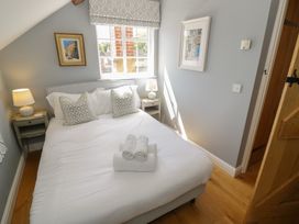 A bedroom with a bed and bedside table at Tea Tree Cottage in Chipping Campden