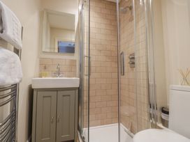 A bathroom with a shower, sink, and toilet at Tea Tree Cottage in Chipping Campden