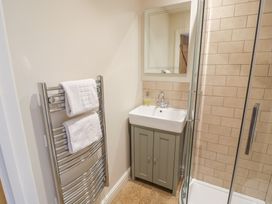 A bathroom with a sink and shower at Tea Tree Cottage in Chipping Campden