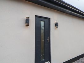 A door with light fixtures on the exterior at Mike’s Place in Rhyl
