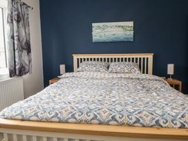 A bedroom with a bed and bedside tables at Mike’s Place in Rhyl