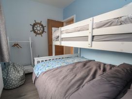 A bedroom with a bunk bed and a bean bag at Mike’s Place in Rhyl