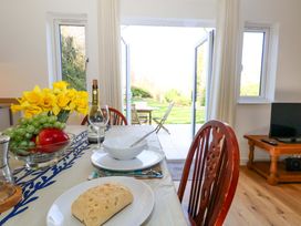 A dining room with a table set for a meal at The Pebble in Dorchester
