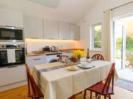 A kitchen with a table set for meals at The Pebble in Dorchester