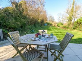 A patio with wooden furniture and a fruit bowl at The Pebble in Dorchester