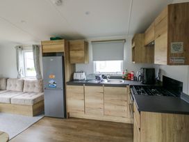 A kitchen with a fridge, stove, and sink at Valley 36 in Kingsbridge