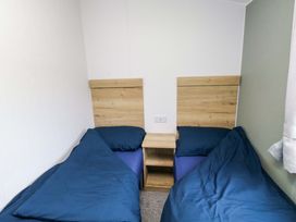 A bedroom with two beds and a nightstand at Valley 36 in Kingsbridge