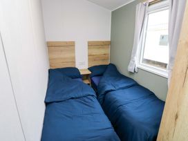 A bedroom with two beds and a window at Valley 36 in Kingsbridge